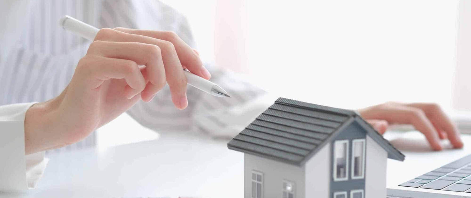 imgi_30_close-up-hand-with-house-model-for-real-estate-check-and-summary-expense-of-home-loan-mortgage-for-refinance-plan-insurance-or-loan-real-estate