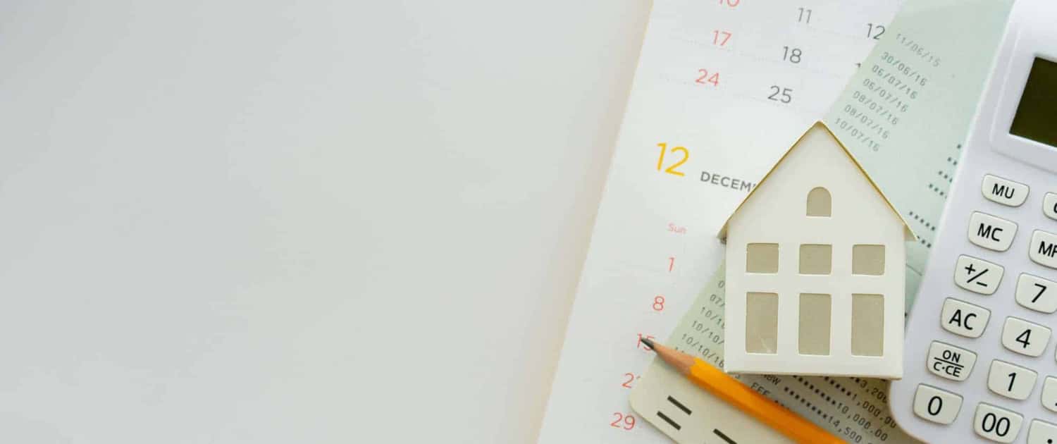 close-up-top-view-group-of-calculator-home-model-yellow-pencil-banking-account-book-and-calendar-on-white-color-background-with-space-for-money